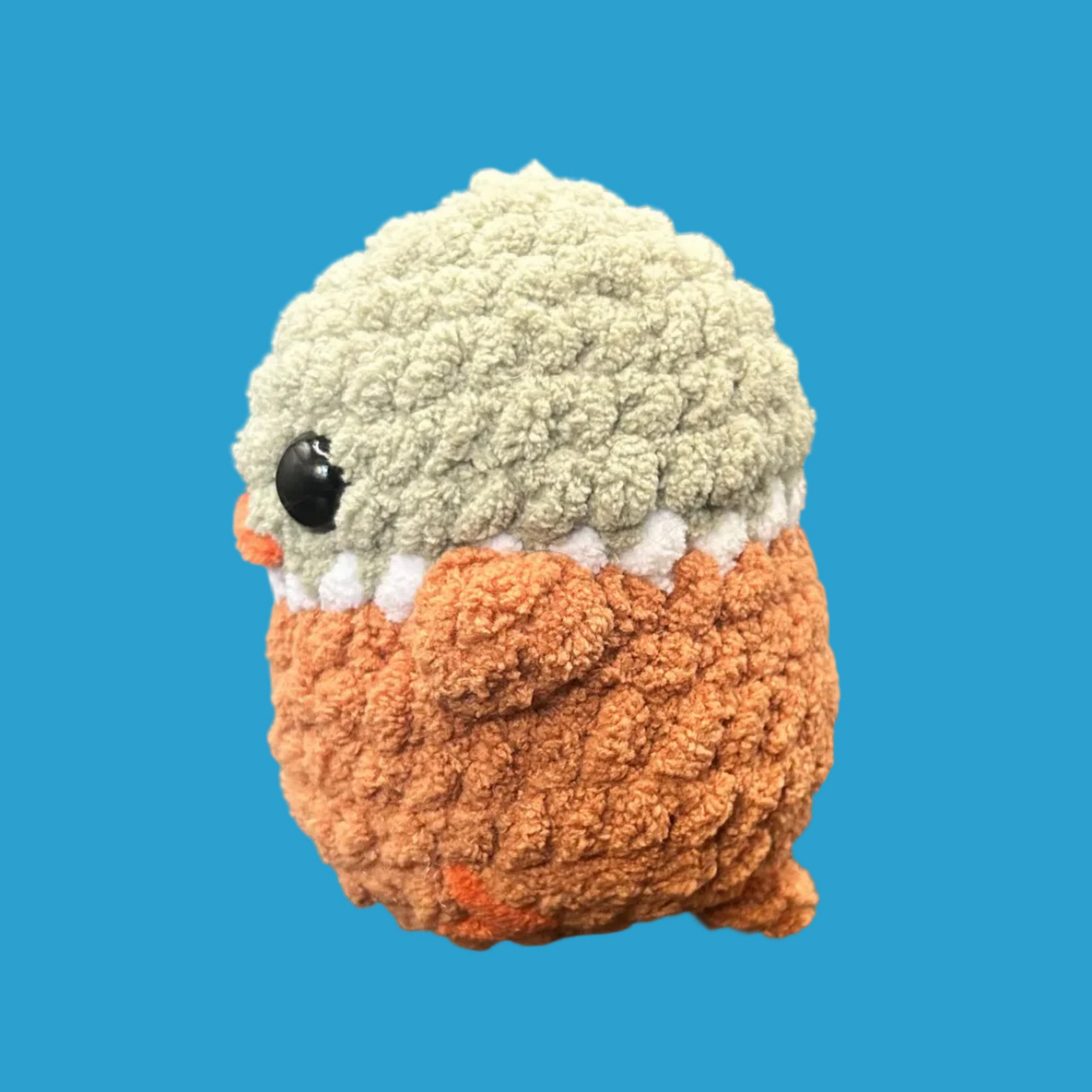 Small plush toy with a textured surface on a blue background