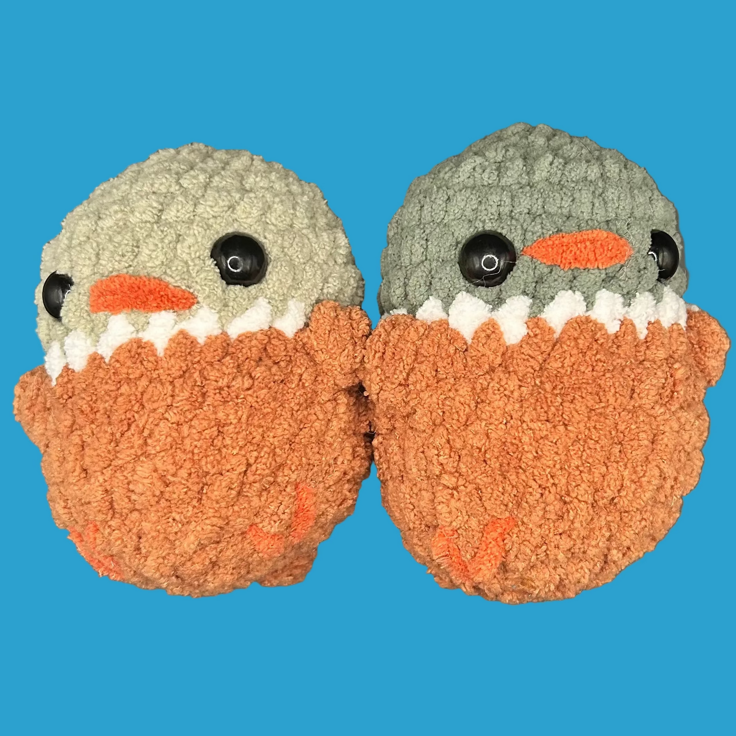 Pair of crochet ducks on a blue background