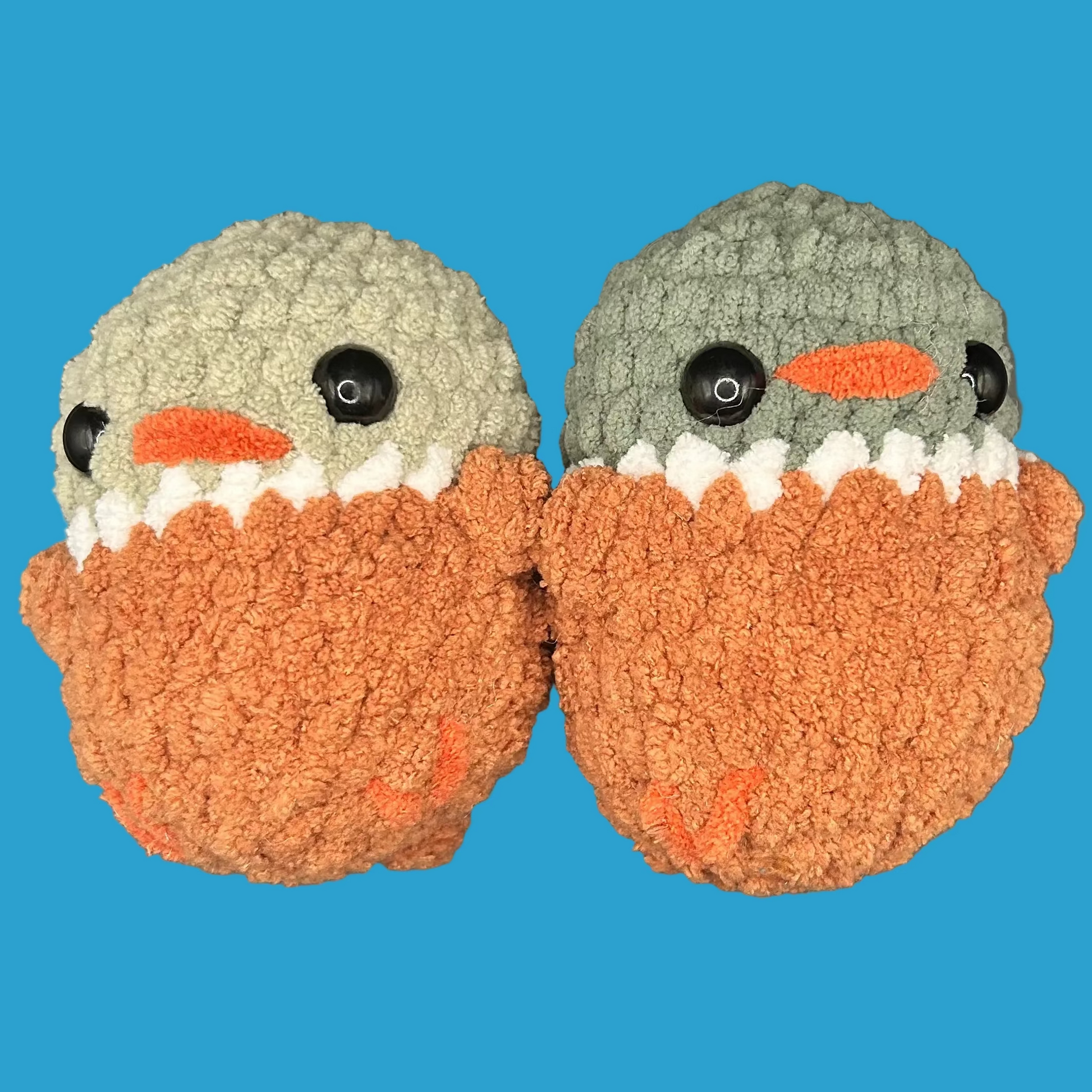 Pair of crochet ducks on a blue background